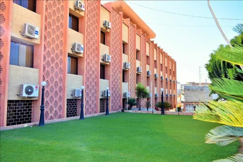 Pameer Hotel building exterior with lawn on G.T. Road Mingora