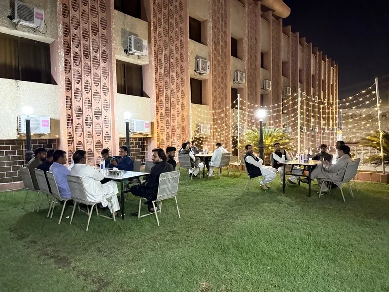 Outdoor walima dinner setup on the lawn at Pameer Hotel Mingora at night